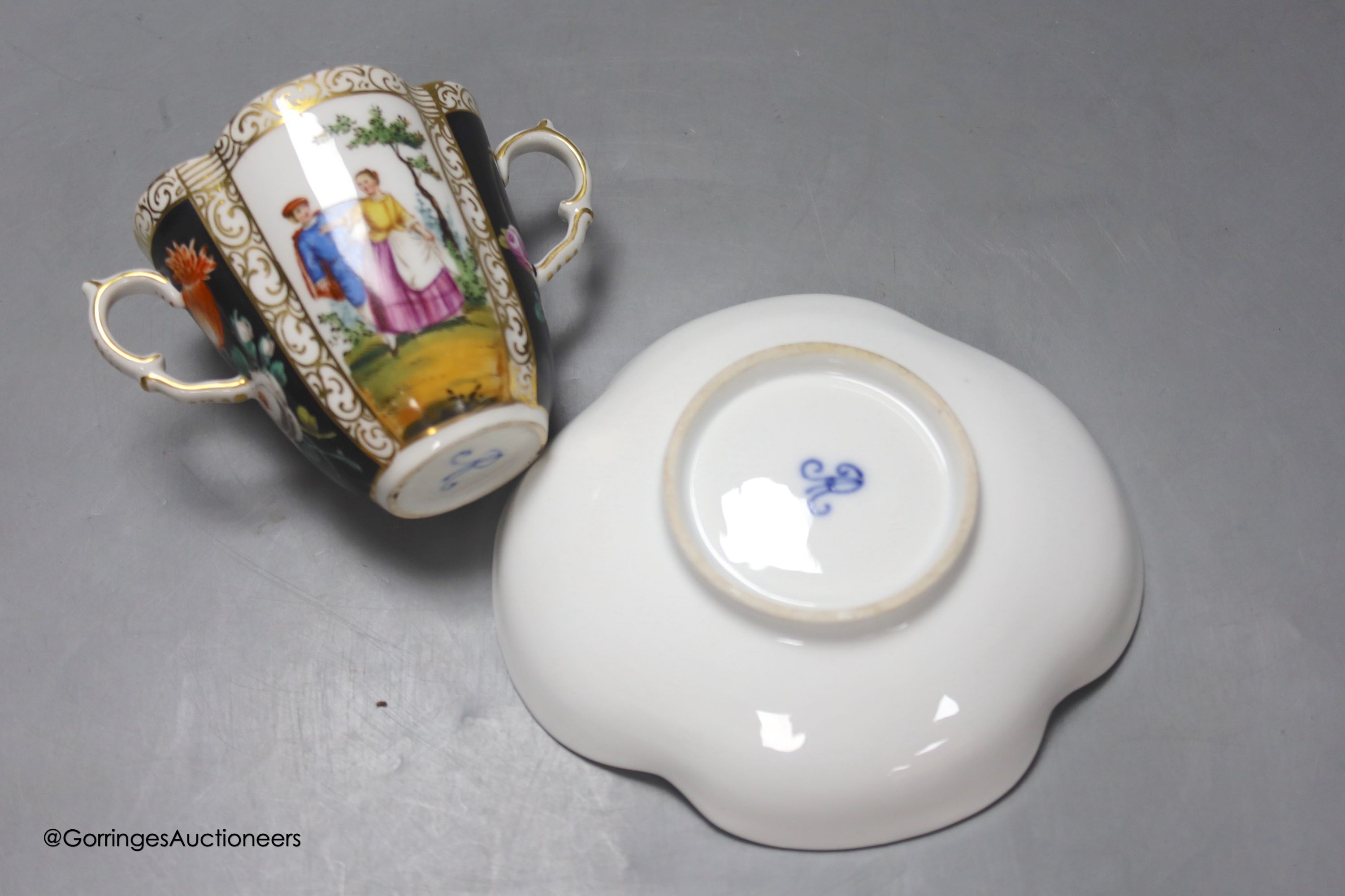 A Dresden two handled cup and saucer, height 8.5cm